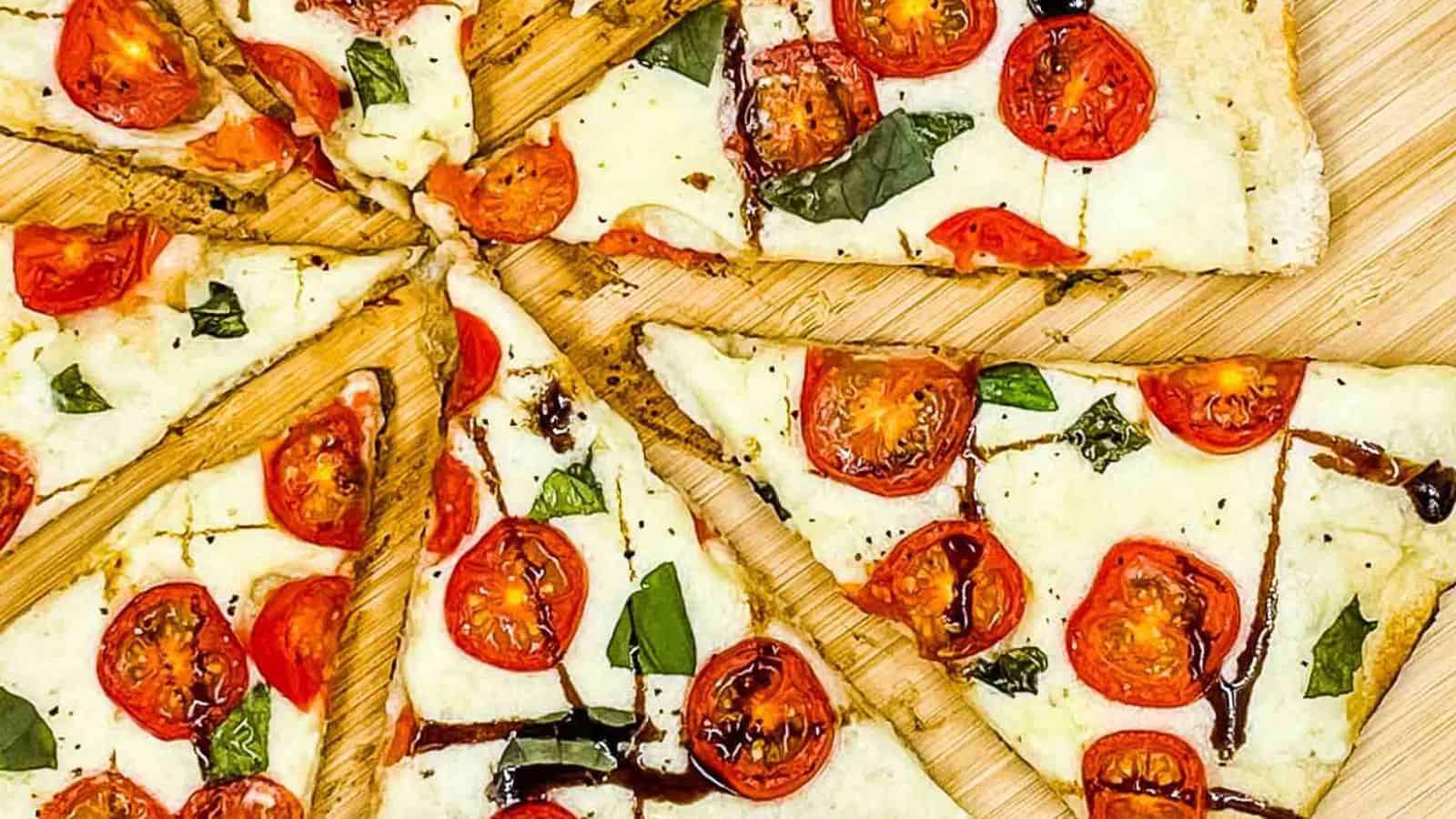 Caprese pizza sliced and ready to eat.