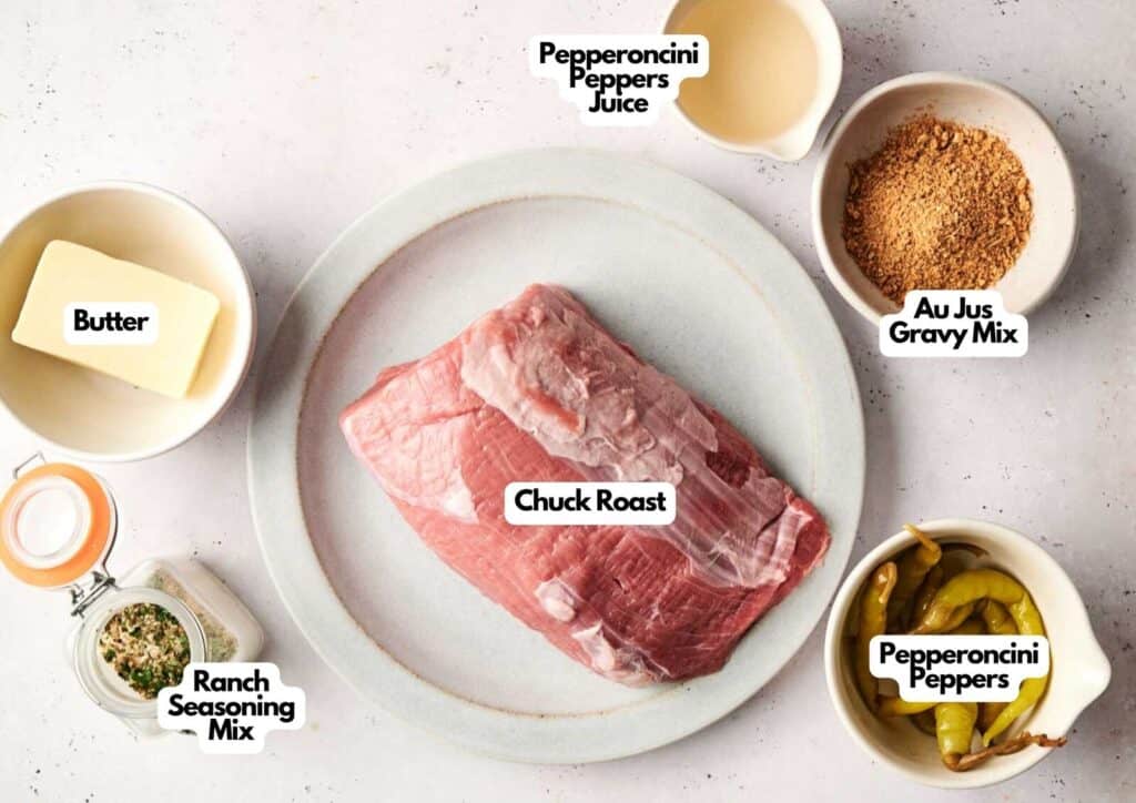 Labeled ingredients for Mississippi pot roast including chuck roast, butter, ranch seasoning, and pepperoncini peppers