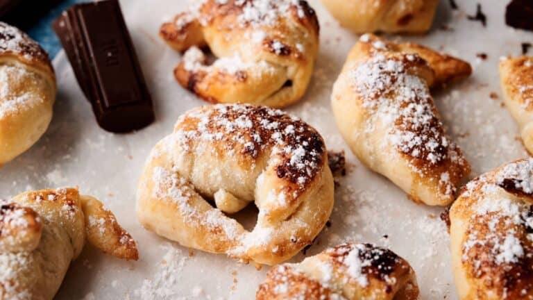 Chocolate and pretzel rolls with powdered sugar.