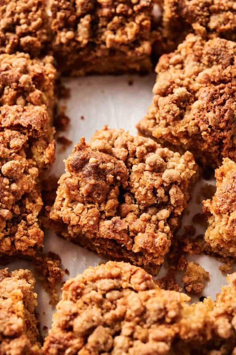 Close-up of crumb-topped Air Fryer Coffee Cake squares arranged on a white surface.