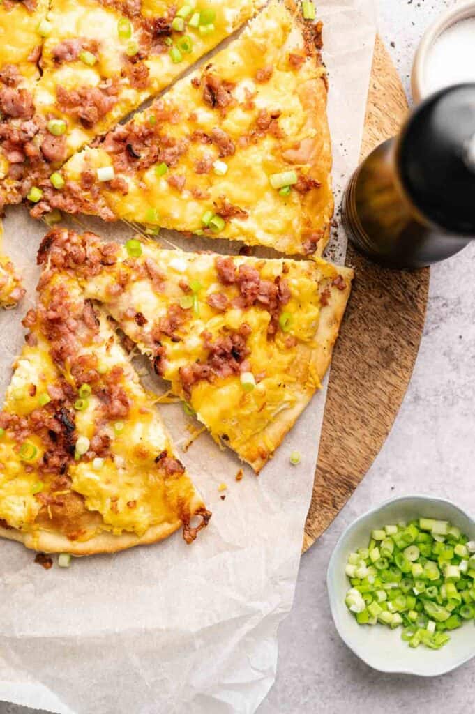 aked breakfast pizza topped with melted cheese, sausage, and scallions