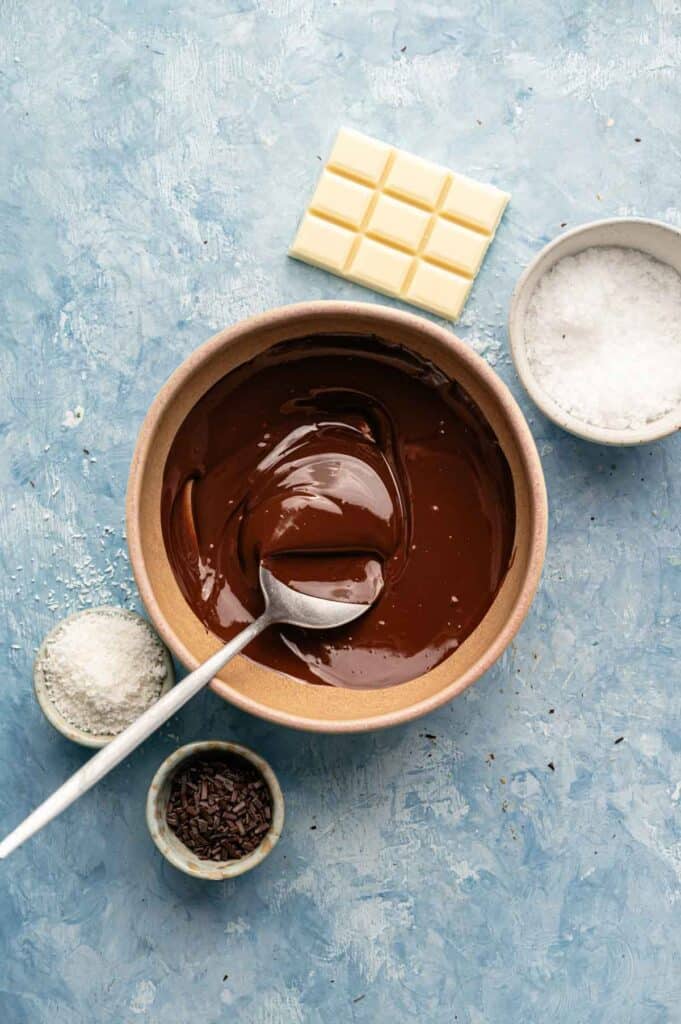 Bowl of glossy melted chocolate ready for dipping pretzels