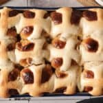 A tray of freshly baked Air Fryer Hot Cross Buns with golden brown tops and white icing crosses on each bun.