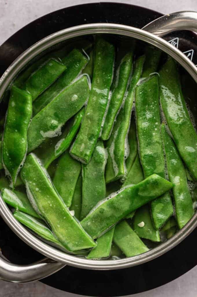 Green beans blanching in a pot of boiling broth