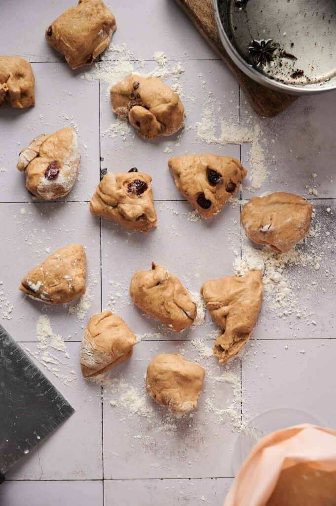 A group of dough on a table, ready to be transformed into delicious Air Fryer Hot Cross Buns.