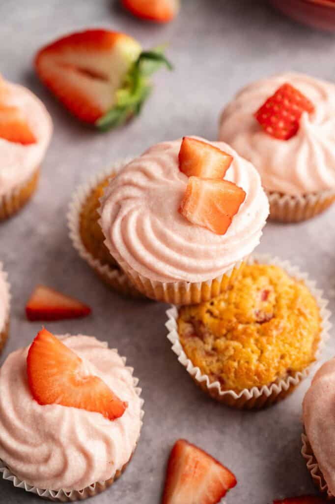 Close-up of frosted strawberry cupcakes garnished with strawberry slices