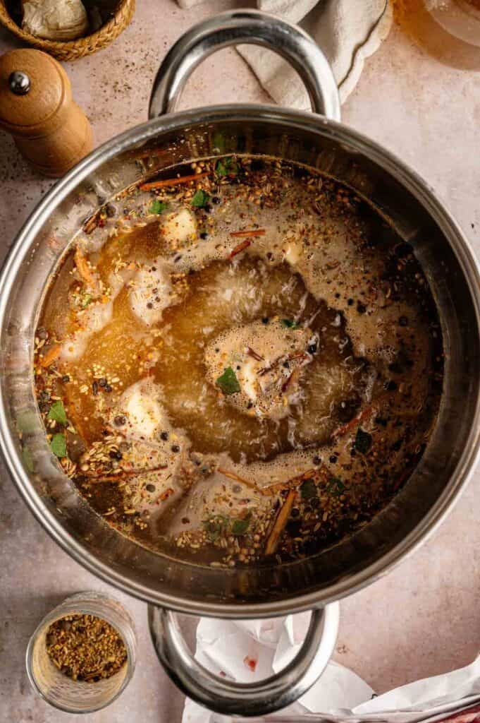 Pickling spices and brine simmering in a pot before cooling