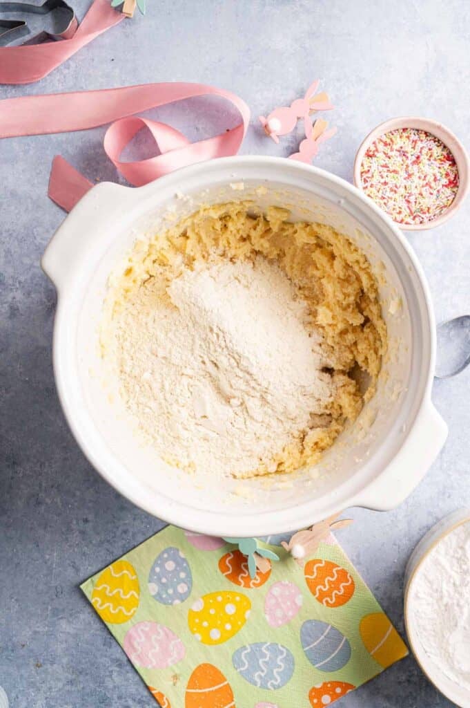Flour added to cookie dough batter in a mixing bowl