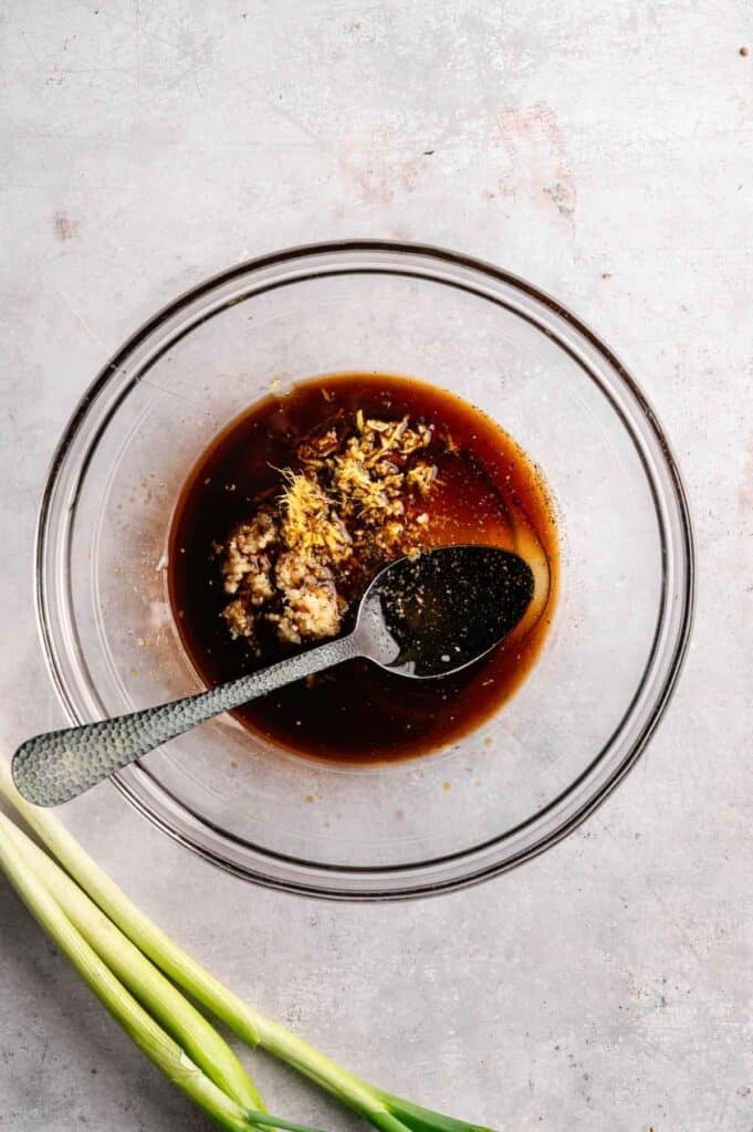 Soy sauce, garlic, and ginger combined in a bowl for the marinade