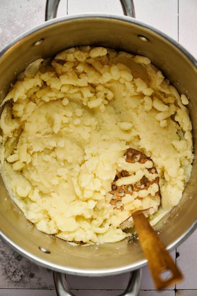 Boiled potatoes mashed smooth in a pot