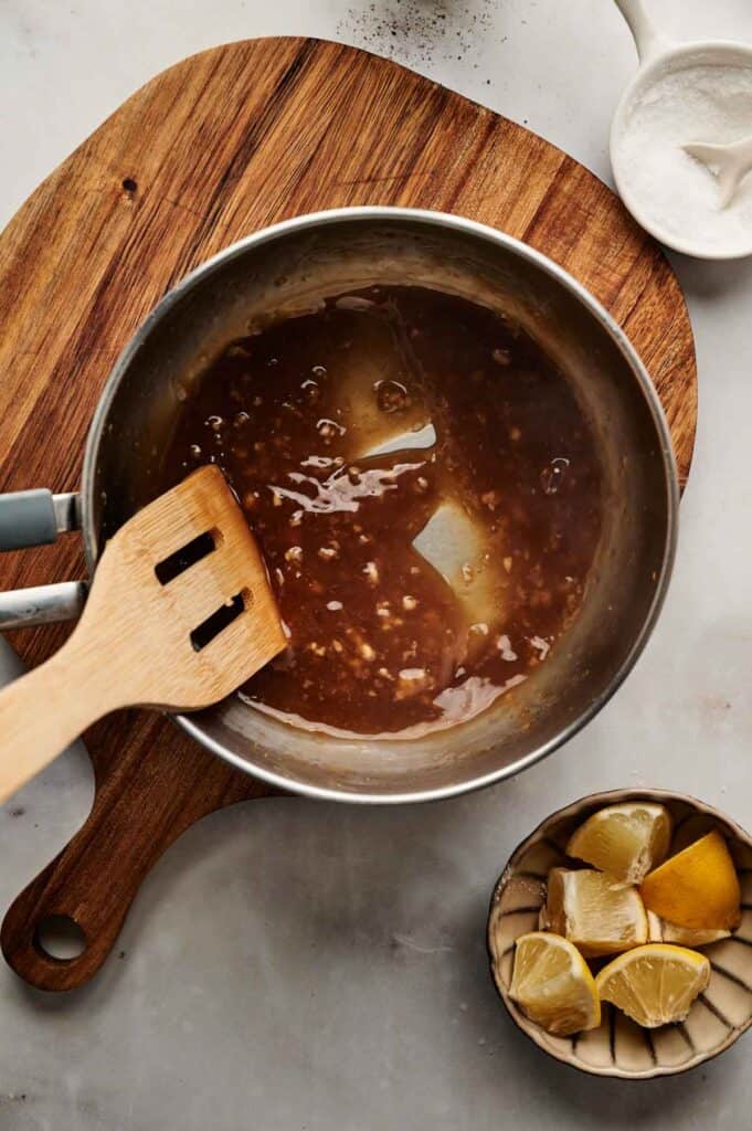 Lemon garlic dipping sauce thickened in a saucepan