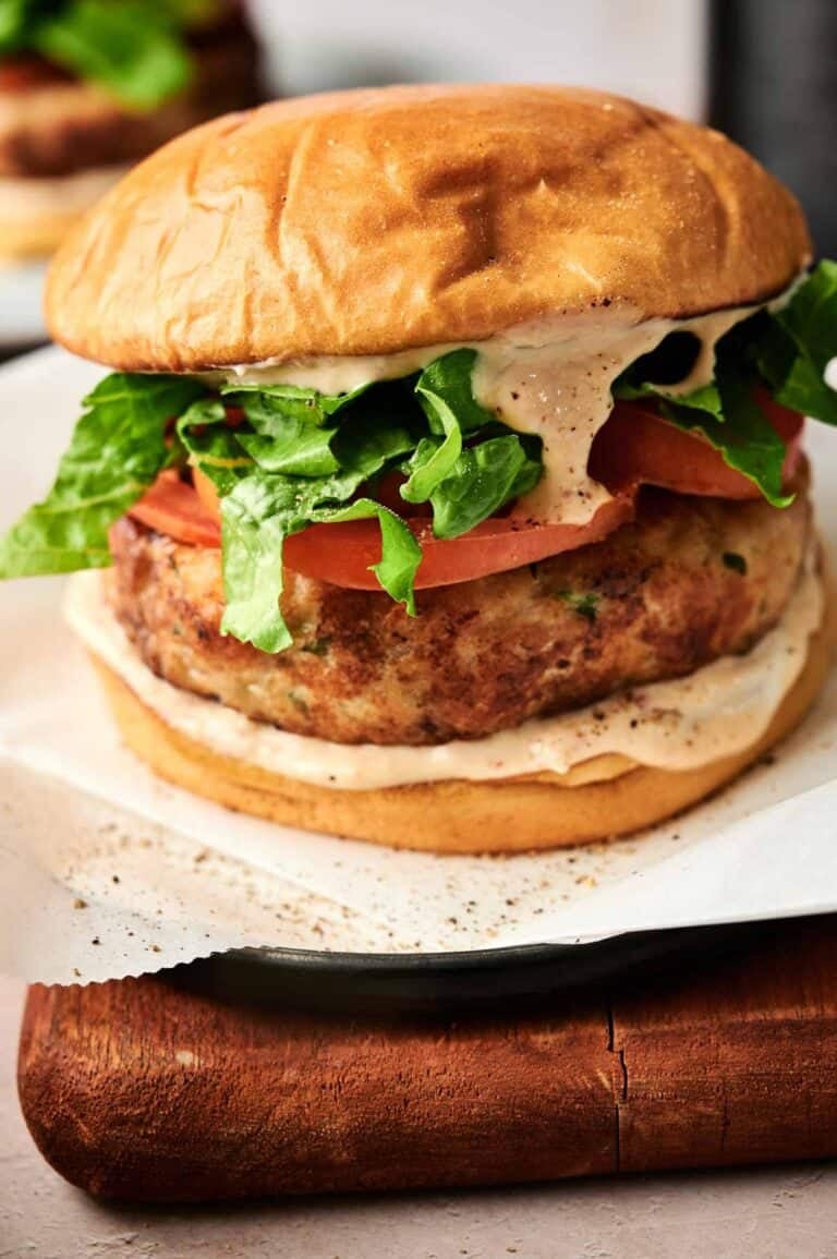 Juicy air fryer turkey burger with fresh lettuce, tomato, and creamy sauce on a toasted bun.