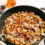 Delicious Honey Butter Skillet Corn with spices and cheese in a skillet.