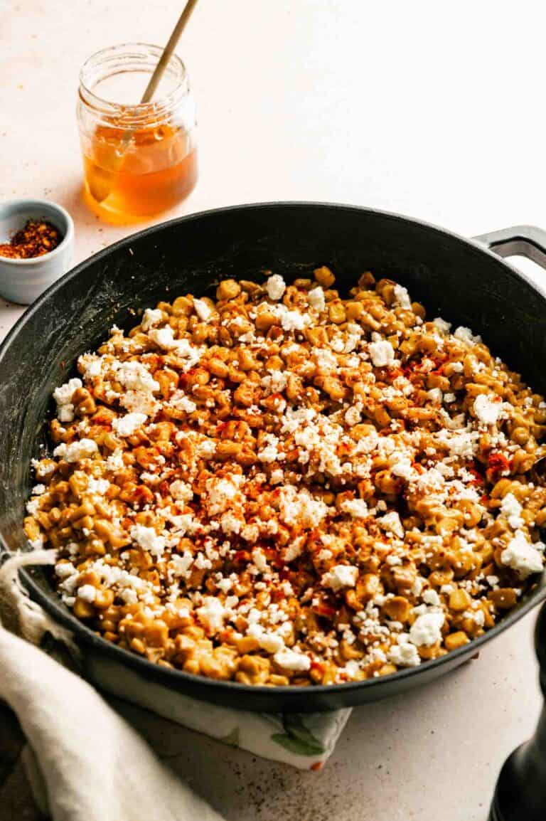 Delicious Honey Butter Skillet Corn with spices and cheese in a skillet.