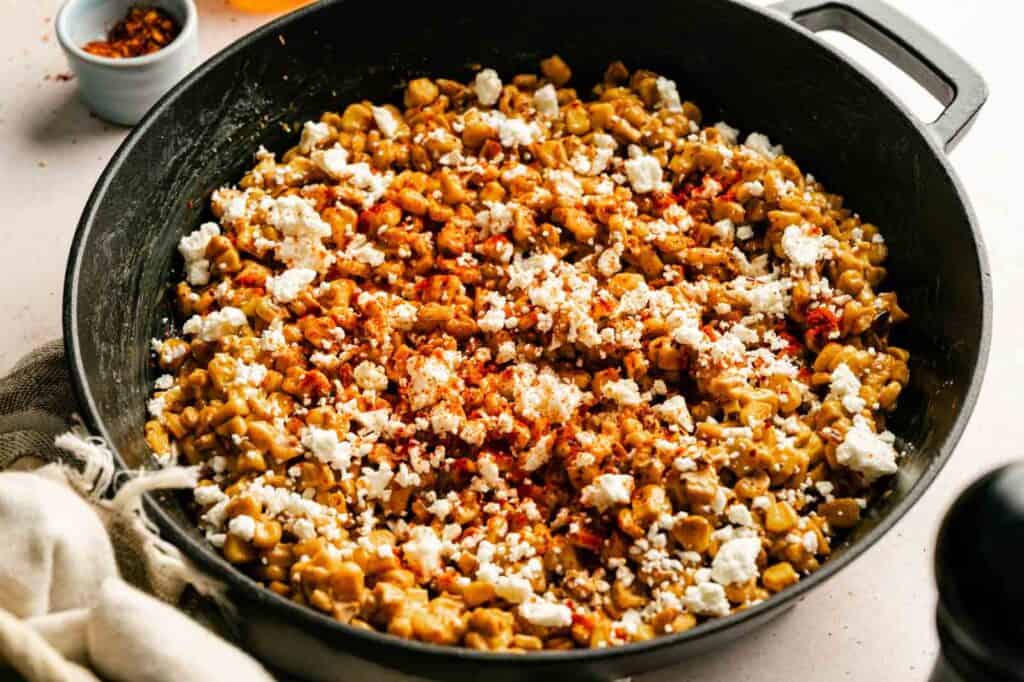 Delicious Honey Butter Skillet Corn with spices and cheese in a skillet.