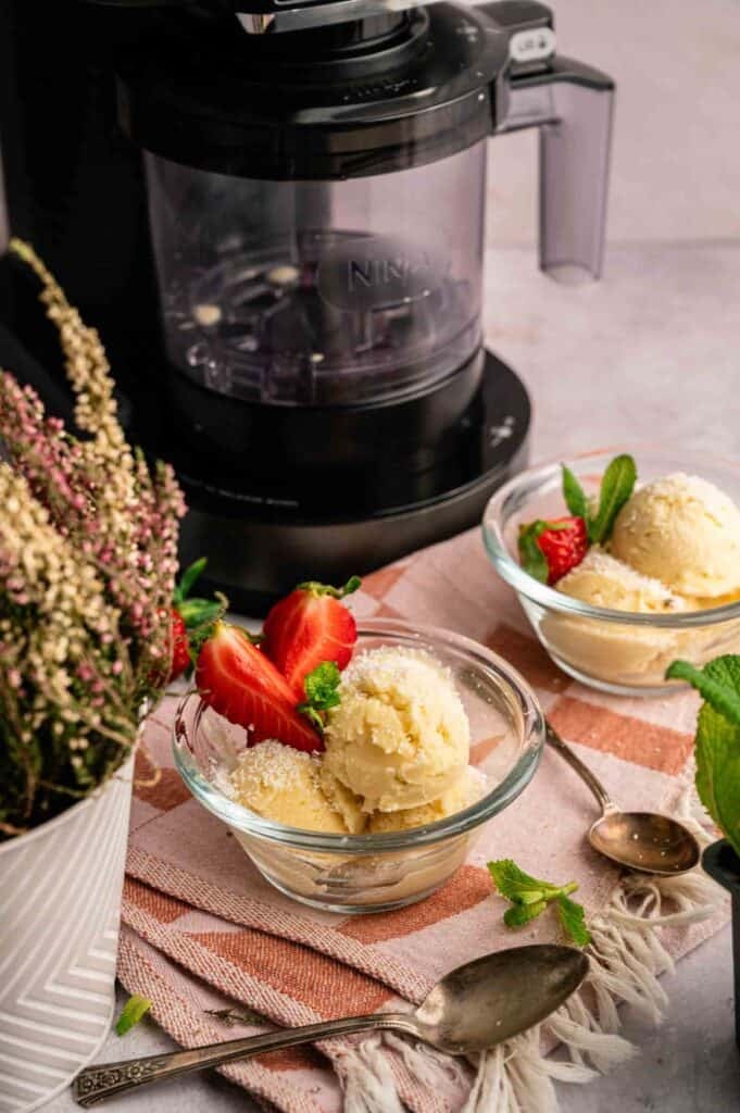 Dola Whip ice cream served in bowls, garnished with strawberries and mint.