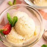 Delicious homemade Dole whip garnished with fresh mint and strawberries. Perfect for summer.