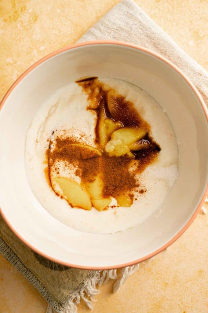 A mixture of peach ice cream base in a bowl.