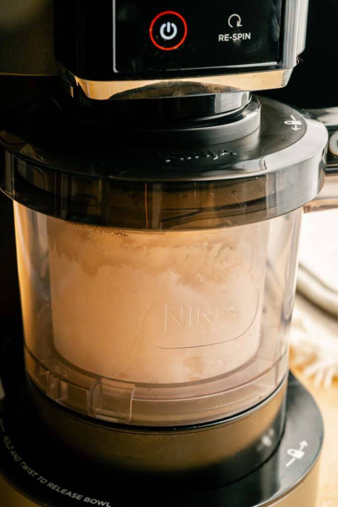 Peach cobbler ice cream mixture being processed in the Ninja CREAMi machine