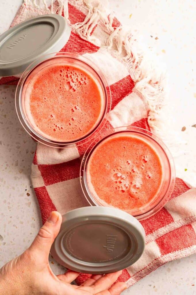 Blended watermelon poured into containers.